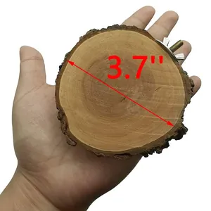 Detail showing a 3.7 inch natural pine wood bird perch with its mounting screw in hand