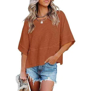 Macro view showing fabric texture and bell sleeve detail of the terracotta T-shirt