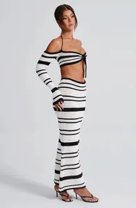 Full side view of a model wearing a striped crochet two-piece set in a studio