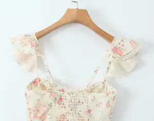 Detail view of the floral print dress back showing smocking and ruffled sleeves