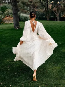 Elegant white pleated jacquard maxi dress with lantern sleeves and open back.