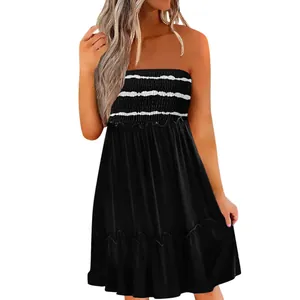 Detailed macro view of women's black strapless smocked dress with white stripes