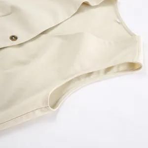 Detailed macro shot of khaki cotton linen vest showcasing fabric texture and button