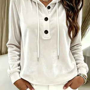 Detail view of a white velvet drawstring hoodie featuring decorative black buttons