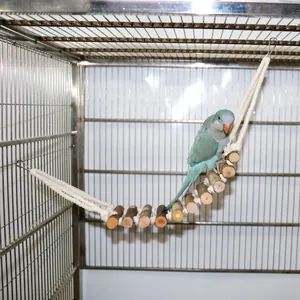 Natural wooden suspension bridge toy for small parrots hanging inside a metal bird cage.