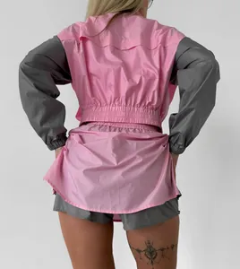 Back view of pink and grey color-block women's sports set with long sleeve jacket