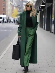 Elegant long green wool coat and matching pants suit for autumn and winter street style look