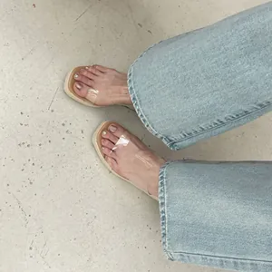 Fashionable women's wedge sandals featuring clear PVC straps and stylish espadrille soles.