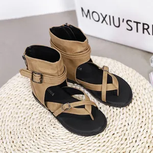 Close-up of khaki Roman-style gladiator sandals with buckle straps and back zipper