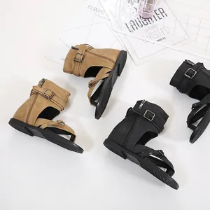 Stylish women's buckled Roman sandals in black and tan colors on white background