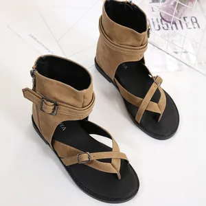 Detailed close-up view of khaki Roman sandals featuring stylish buckles and soft black soles