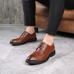 Detailed view of men's brown leather business dress shoes with elegant lace-up design