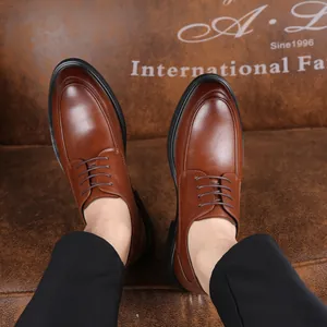 Close-up view of elegant brown leather business dress shoes with stylish lace-up design.