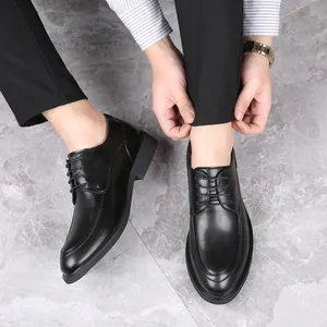 Close-up detail of men's black leather lace-up business dress shoes with height-increasing sole