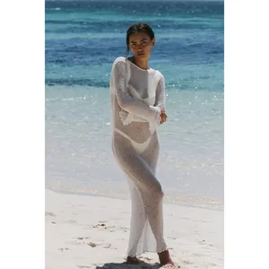 Detailed view of a white sheer long-sleeved knitted maxi dress for beach vacation wear