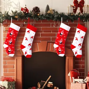 Festive set of 4 knitted red and white Christmas stockings with gnome patterns hanging