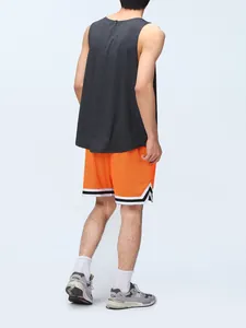 Rear view of men's orange mesh basketball shorts with black and white striped trim