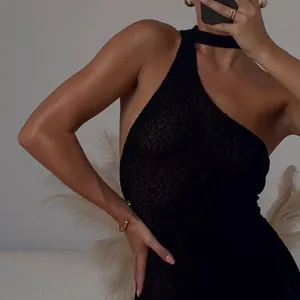 Detail of black one-shoulder knit bodycon dress showing textured fabric and fit