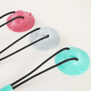 Three colorful octopus-shaped suction cup dog toys with ropes on a white background.