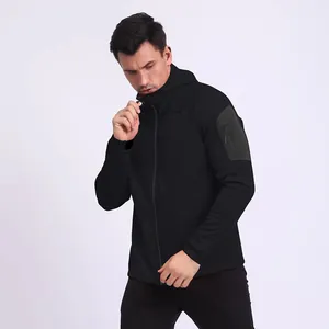 Close-up detail of a men's black sports zip-up hoodie featuring a functional sleeve pocket.