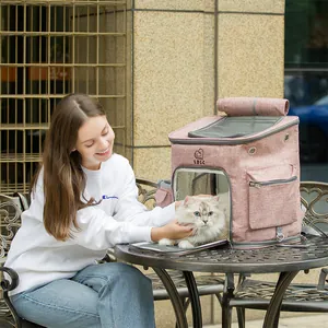 Large pink breathable cat carrier backpack with a white cat shown in an outdoor park setting