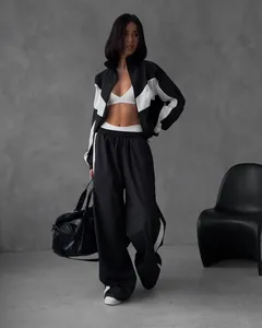 Full view of women's black and white loose-fit tracksuit with zip-up jacket and pants.