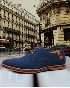 Side view detail of blue suede men's casual derby shoe featuring tan laces and stitching