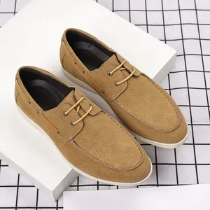 Detailed view of men's camel brown suede loafers featuring a classic British lace-up design
