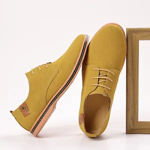 Detailed view of yellow suede men's casual shoes with lace-up design and wood frame.