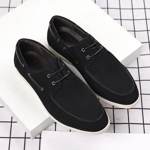 Detailed view of men's black suede casual loafers with white soles and laces