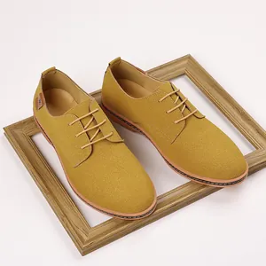 Top-down view of yellow suede men's casual shoes presented inside a rustic wooden frame