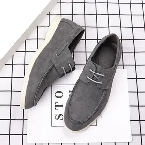 Close-up of men's gray suede casual loafers with minimalist British style design.