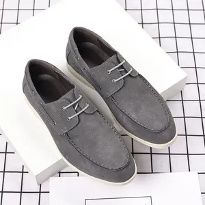 Casual grey suede loafers for men in a stylish British design shown on white blocks