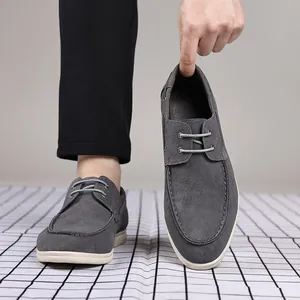 Detailed close-up of grey suede men's loafers highlighting the soft texture and design