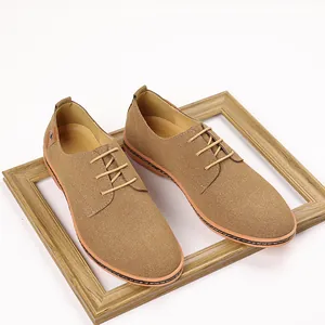 Detailed macro view of men's tan suede casual derby shoes featuring elegant lace-up closure