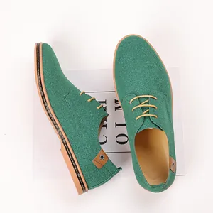Detail view of green suede men's casual shoes showing texture and lace design.