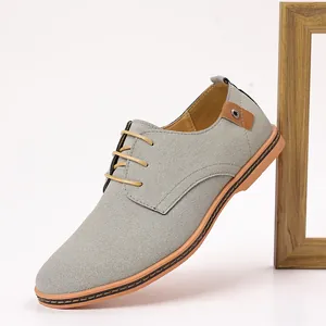 Detailed side view of grey suede men's casual dress shoes with lace-up closure.