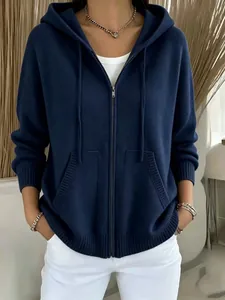 Close-up front view of women's navy blue knitted zip-up hoodie with hood and pockets.