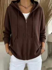 Close-up view of a stylish brown knitted zip-up hoodie featuring a hood and front pockets