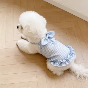 Detailed view of breathable light blue checkered dog dress with bow and ruffled edge