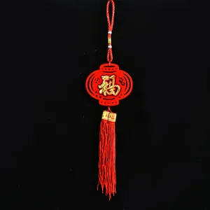Close-up of Chinese New Year red felt lantern ornament with gold Fu character and tassel.