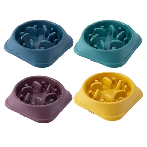 Set of four colorful pet slow feeder bowls in navy blue, teal, purple, and yellow