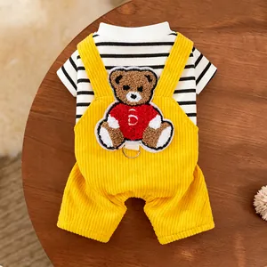 Detailed view of yellow corduroy dog overalls featuring a cute bear embroidery