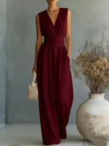 Close-up of elegant burgundy sleeveless V-neck jumpsuit with a cinched pleated waist.
