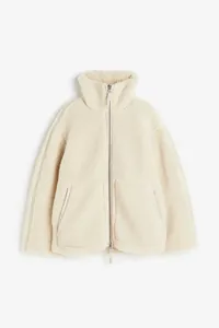 Gemütliche cremefarbene Oversize-Sherpa-Fleecejacke mit hohem Kragen und Reißverschluss.
