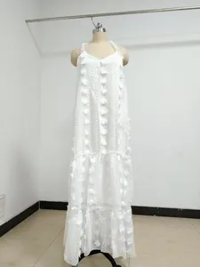 Full-length view of white maxi dress featuring 3D floral textures and tiered cake skirt design