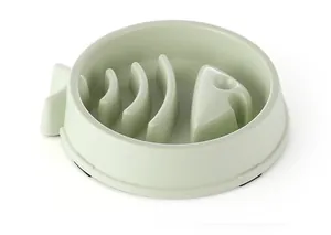 Green fish-shaped slow feeder dog bowl with anti-choke ribbed interior design.