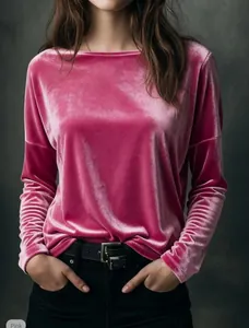 Close-up detail of luxurious pink velvet fabric on a loose round-neck top.