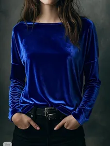 Macro view showing the luxurious luster of blue velvet fabric on a long-sleeved top