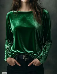 Close-up of elegant emerald green velvet long-sleeve top showing rich fabric texture